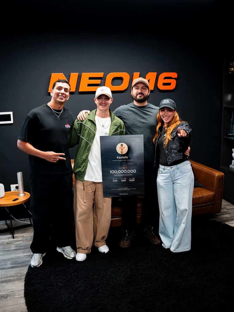 Kastelo receiving a 100,000,000-stream Muso.AI plaque at the NEON16 office